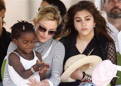 Madonna sits with her adopted Malawian child James and daughter Lourdes during a bricklaying ceremony at the site of her Raising Malawi Girls Academy